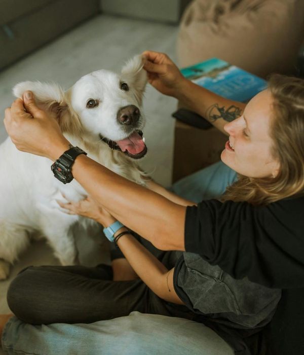 Woman with closed eyes, looking calm and relaxed in a softly lit room.